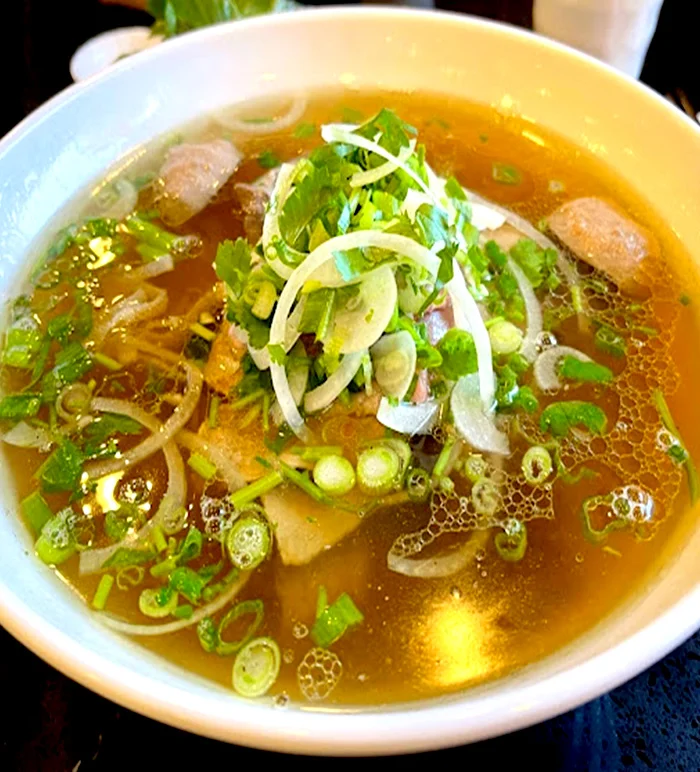 A bowl of Viet Taste beef phở with fresh herbs